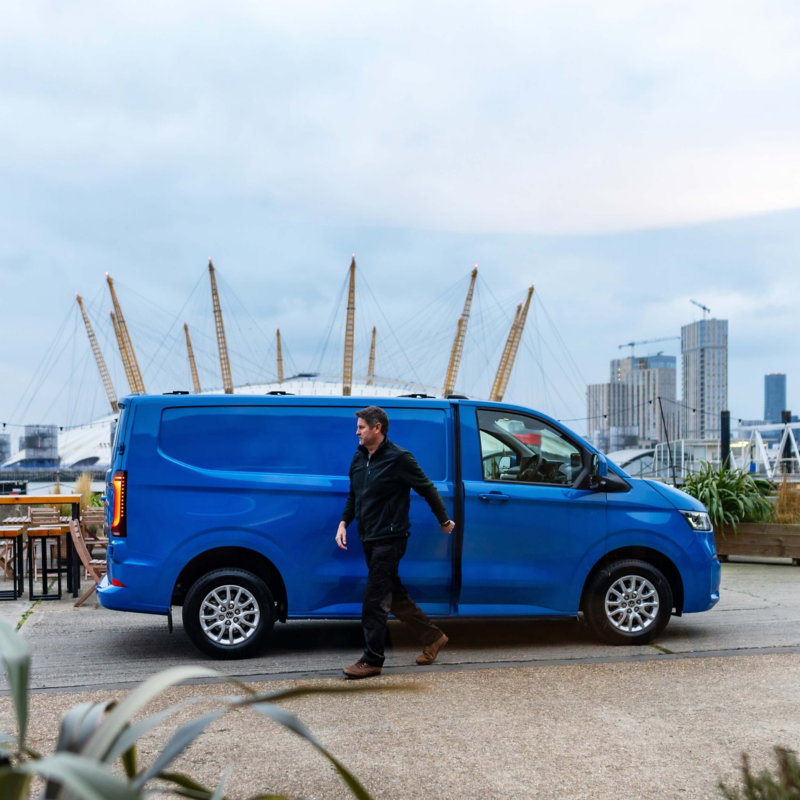 Blue VW Transporter parked with the O2 arena in the background