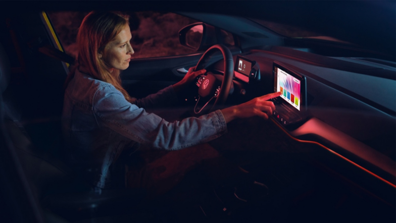 A woman navigating the infotainment system in her VW.