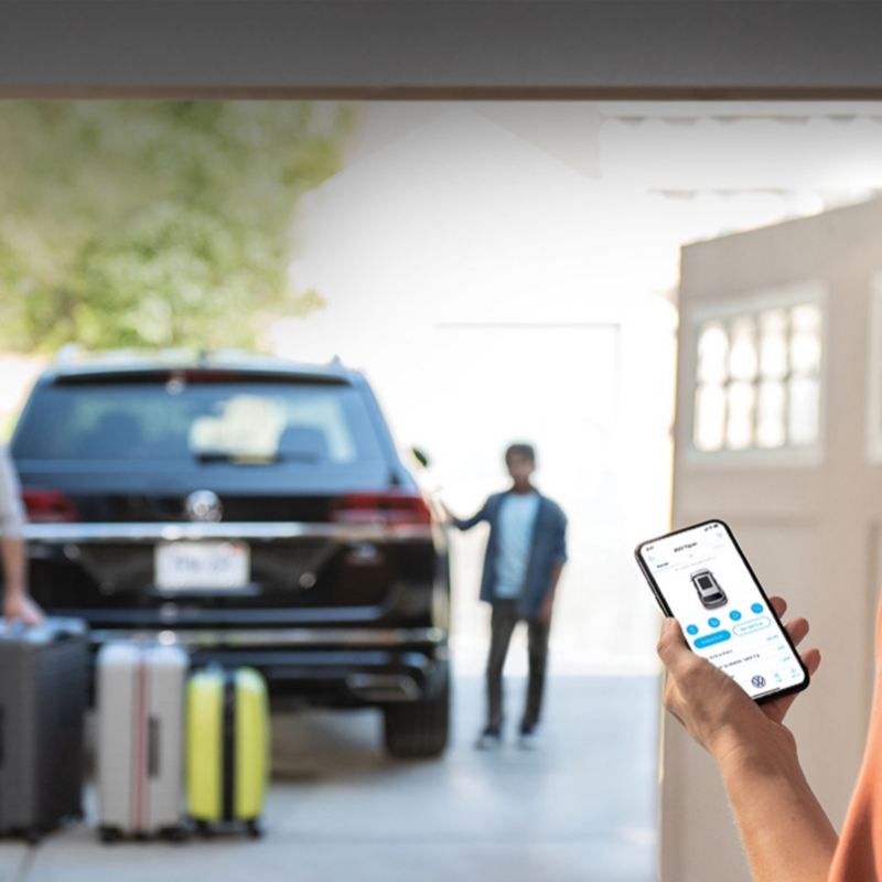  A Car-Net® app on a phone with a VW car in the background