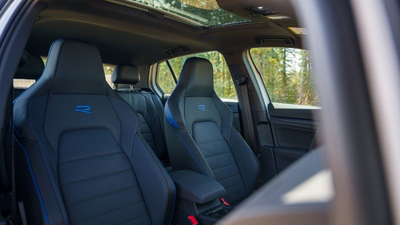 Volkswagen’s Golf R 2024 interior with black seats adorned with blue accents and an ‘R’ emblem stitched into the headrests.