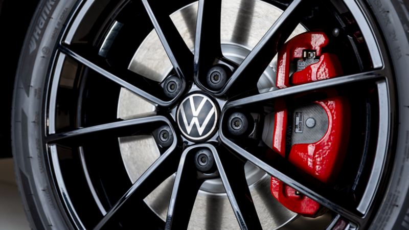 Close-up of 2023 VW Jetta GLI wheel with vibrant red brake pads.