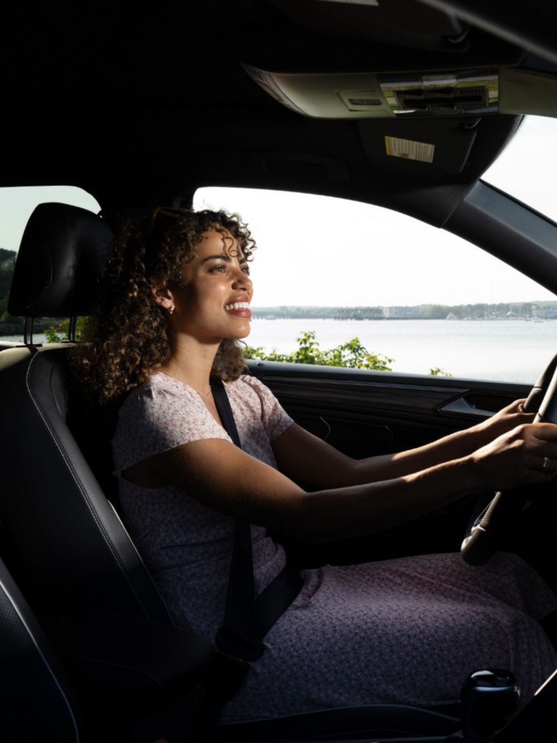 Interior shot of a woman driving a vehicle