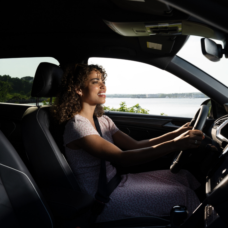 Interior shot of a woman driving a vehicle