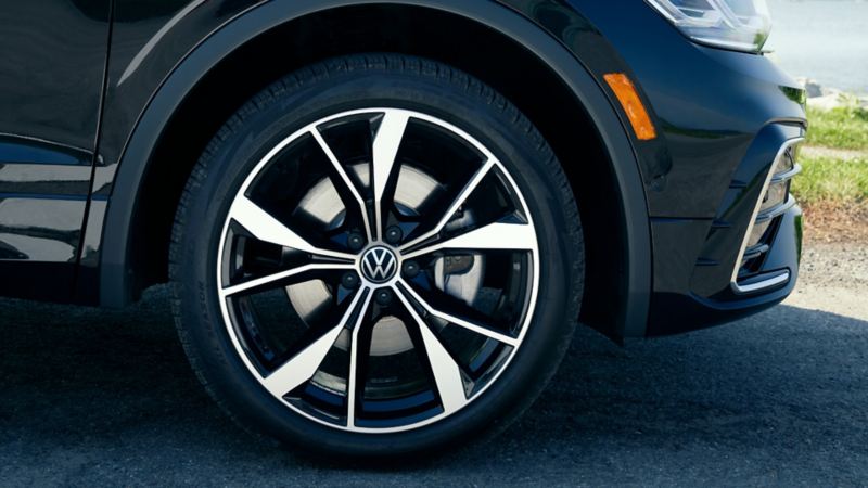 Close-up of the front wheel of a black Volkswagen