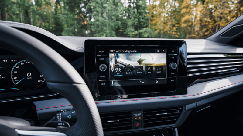 Close-up of the 2025 VW Jetta GLi touchscreen display, showcasing the  Dynamic Chassis Control (DCC) feature.