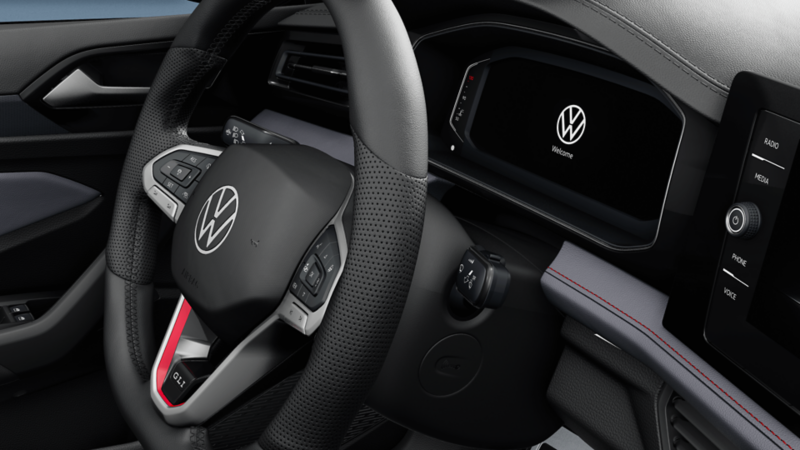 Close-up of the 2025 VW Jetta GLI steering wheel and digital cockpit, highlighting the vehicle's dashboard and controls.
