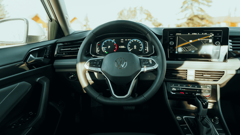 Interior cockpit view of the 2026 Volkswagen Jetta showing steering wheel, digital instrument cluster, and infotainment display.