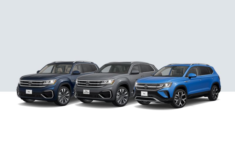 An Atlas in Tourmaline Blue Metallic, an Atlas Cross Sport in Pure Gray, and a Taos in Cornflower Blue, lined up next to each other.