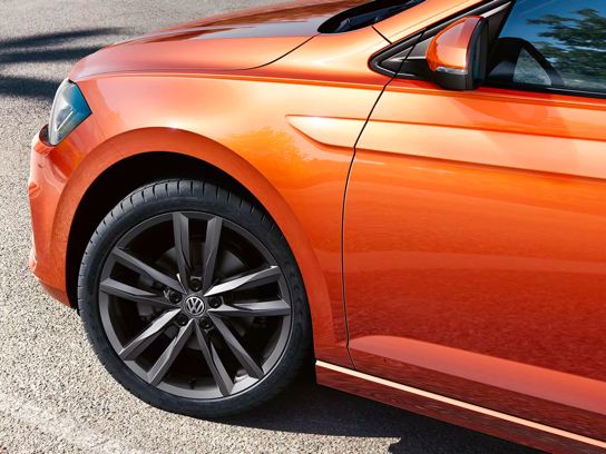 An angled front driver’s side silhouette showcases a habanero orange Volkswagen Jetta.