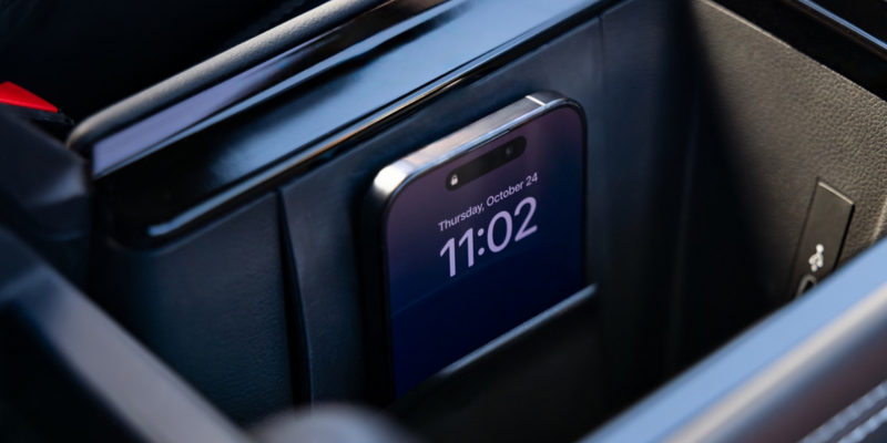 A compatible cell phone charges using the wireless charger in a Tiguan.