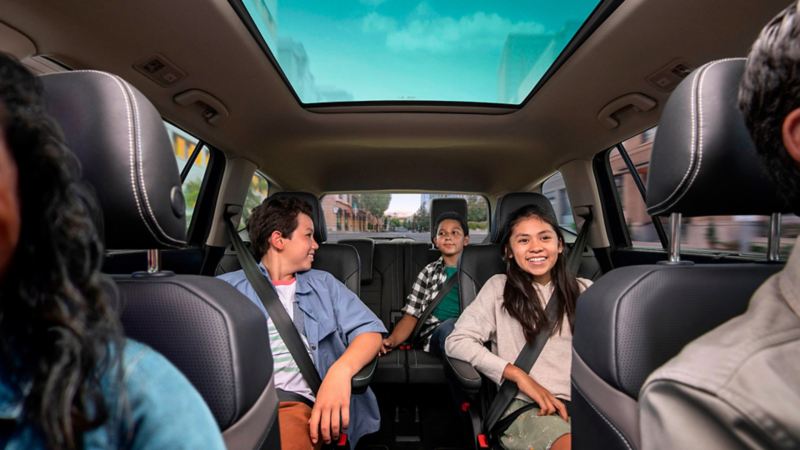 A family sitting inside the 2023 VW Atlas.