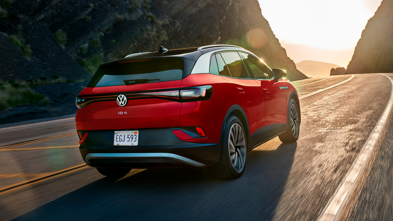 2023 VW ID.4 EV in Aurora Red Metallic, shown from rear three-quarters view.