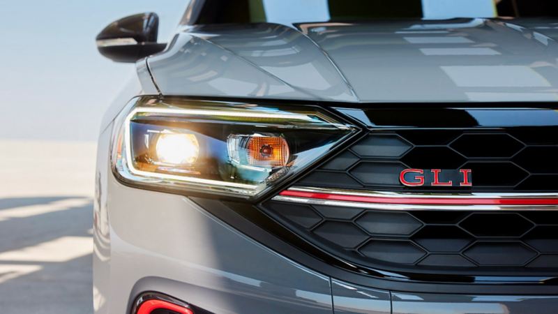 Headlight and grille of 2023 VW Jetta GLI, shown in Pure Gray.