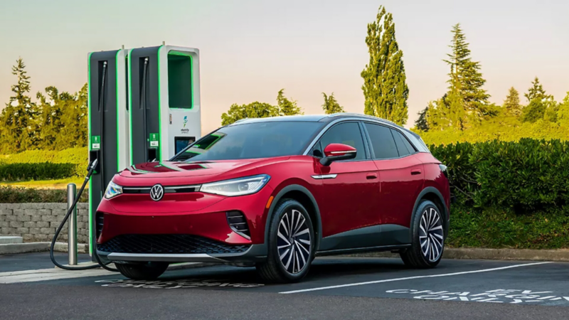 Woman charging VW ID.4 at Electrify America EV charging stations.