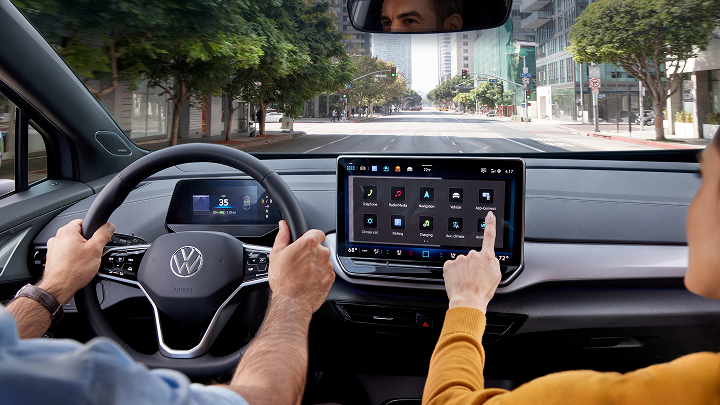 The interior of a Volkswagen Cross Sport with a city seen through the windshield.