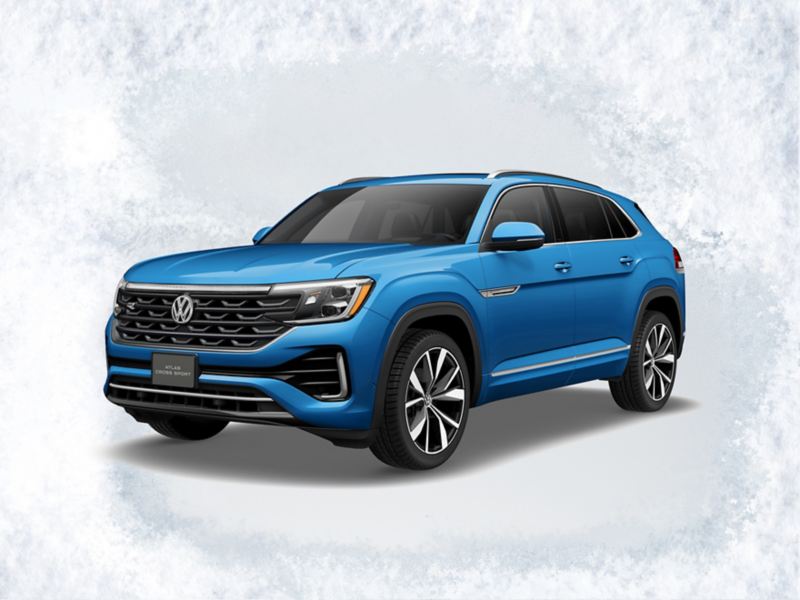 A front ¾ profile view of the Atlas Cross Sport shown in Kingfisher Blue Metallic on a light gray textured background with text ‘Sign then Drive Sales Event’ above.