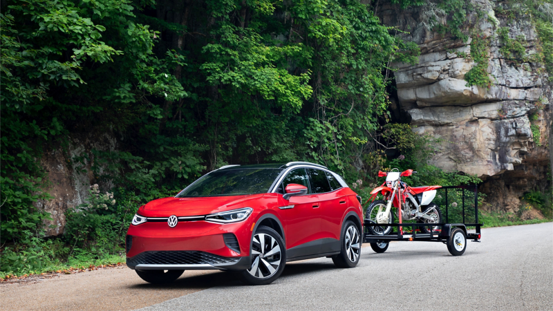 2021 Volkswagen ID.4 EV towing a trailer and motorcycle