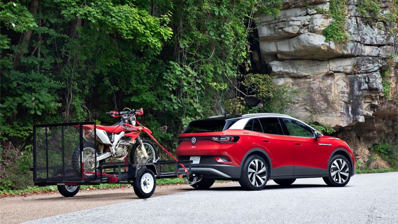 2021 Volkswagen ID.4 EV towing a trailer and motorcycle