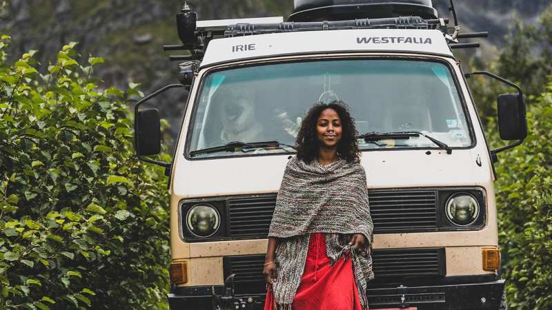Woman stands in front of Volkswagen Vanagon Westfalia
