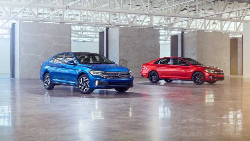 Product shot of the 2022 Volkswagen Jetta and 2022 Volkswagen 2022 Jetta GLI side by side in a studio.