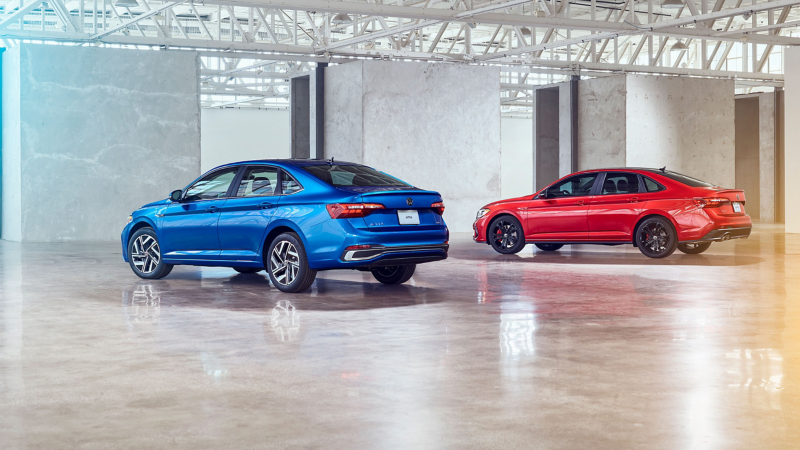 Product shot of the 2022 Volkswagen Jetta and 2022 Volkswagen 2022 Jetta GLI side by side in a studio.