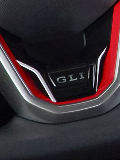Closeup of GLI badge at the bottom of the steering wheel of a VW Jetta GLI.