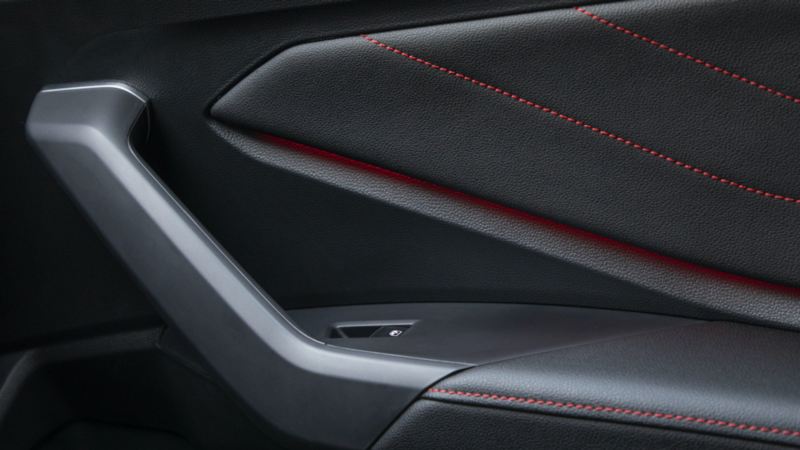 Closeup of red stitching on the seating surfaces of a VW Jetta GLI.