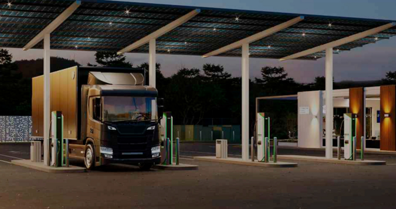 Photo illustration: an electric truck charging at an Electrify America charging station.