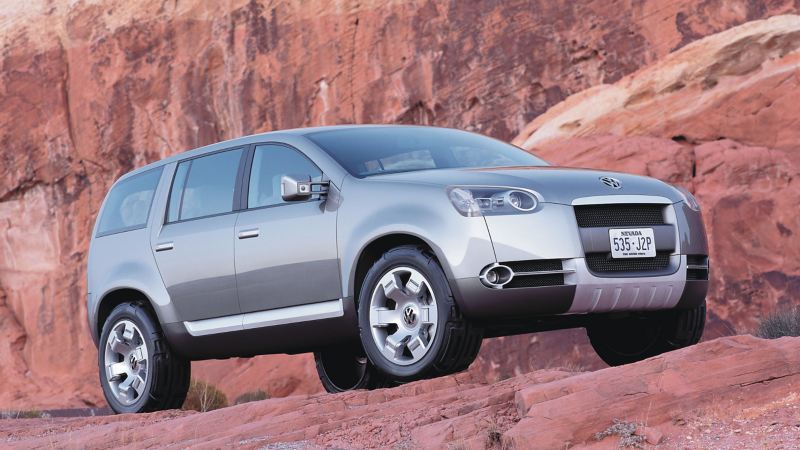 2002 Volkswagen Magellan concept car is parked on red rocks in front of a mountain, showing front and side views of the vehicle.