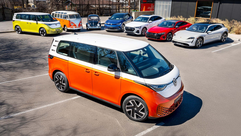 The Volkswagen ID. Buzz sits in front of a lineup of Volkswagen Group vehicles.