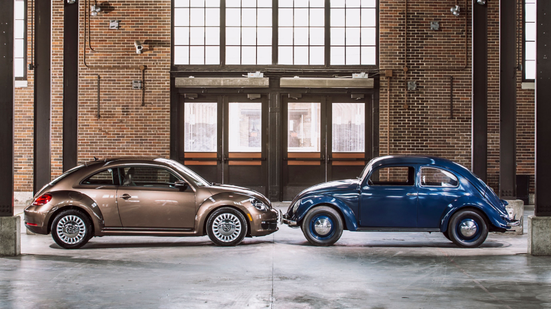 A profile shot of a 2014 Volkswagen Beetle nose to nose with a 1949.