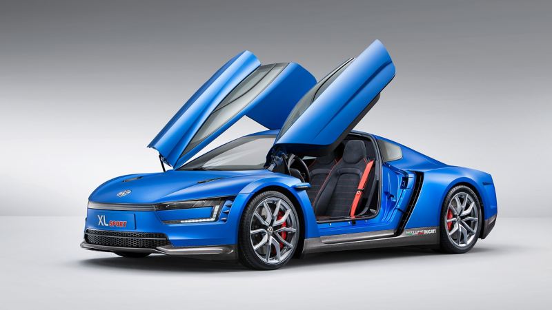 2014 Volkswagen XL Sports concept car is parked with its butterfly doors open, showing front and side views of the vehicle.
