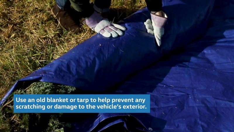 Use an old blanket or tarp to help prevent any scratching or damage to the vehicle’s exterior.