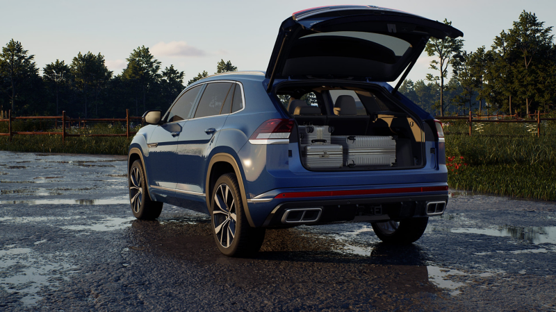 Rear view of a parked Altas Cross Sport shown in Mountain Lake Blue Metallic with the rear liftgate open showing properly secured luggage in the cargo area.