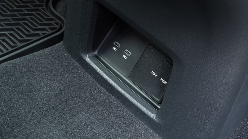 Close-up view of the available 115v outlet in the 2nd row of the Atlas Cross Sport.