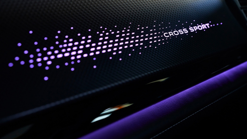 Close-up view of the front dash with the words Cross Sport and a pattern illuminated of the Atlas Cross Sport.