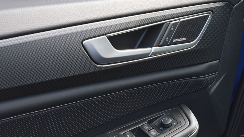 A close-up view of the driver interior door showing the controls and Harman/ Kardon speaker on an Atlas Cross Sport.