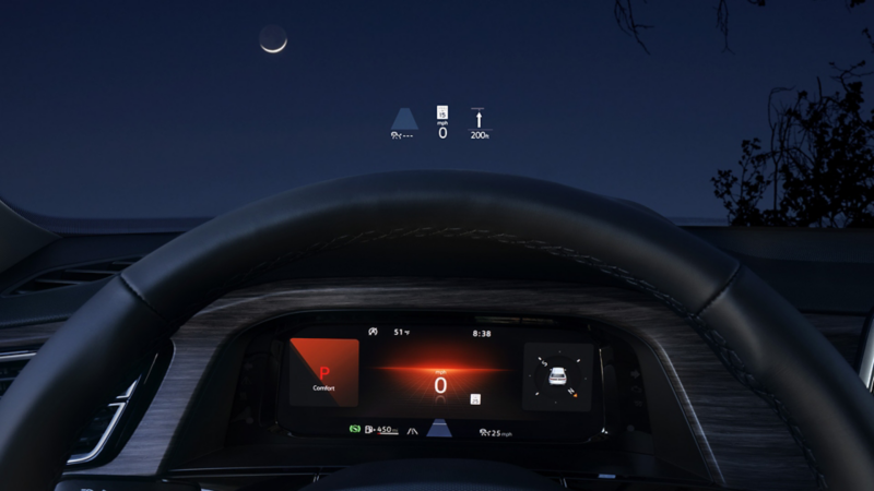 Interior view of an Atlas showing the steering wheel and head-up display information on the windshield.