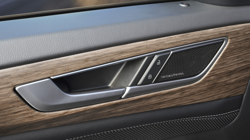 An interior close-up of a Harman Kardon badge on the door speaker of an Atlas