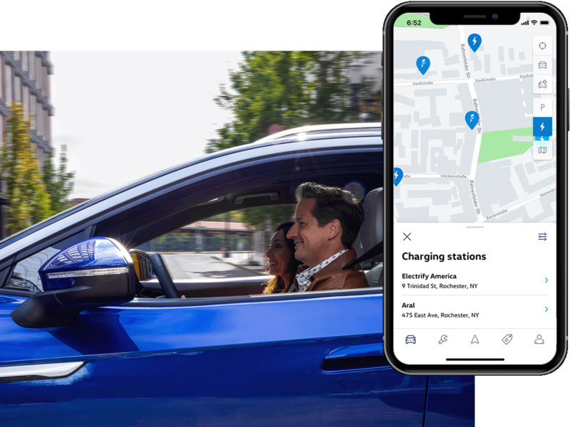 Insideshot of a man driving an ID.4. The MyVW app is displayed on a superimposed mobile phone.