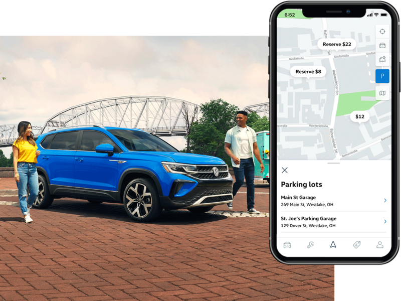 A Taos in Cornflower Blue parked in front of a lake as seen from behind.The MyVW app is displayed on a superimposed mobile phone.