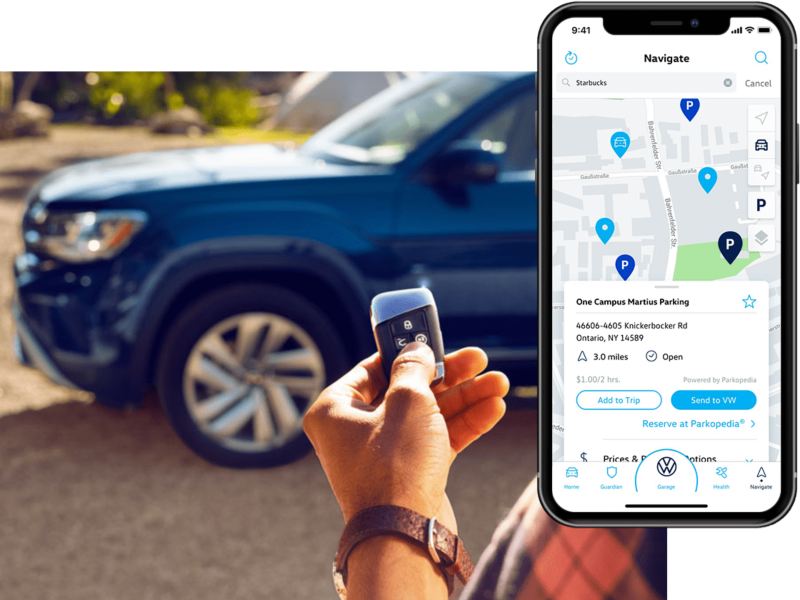 A man clicks his VW remote standing near his vehicle. On his phone, we see the in-app Volkswagen Car-Net® Remote Access parking info.