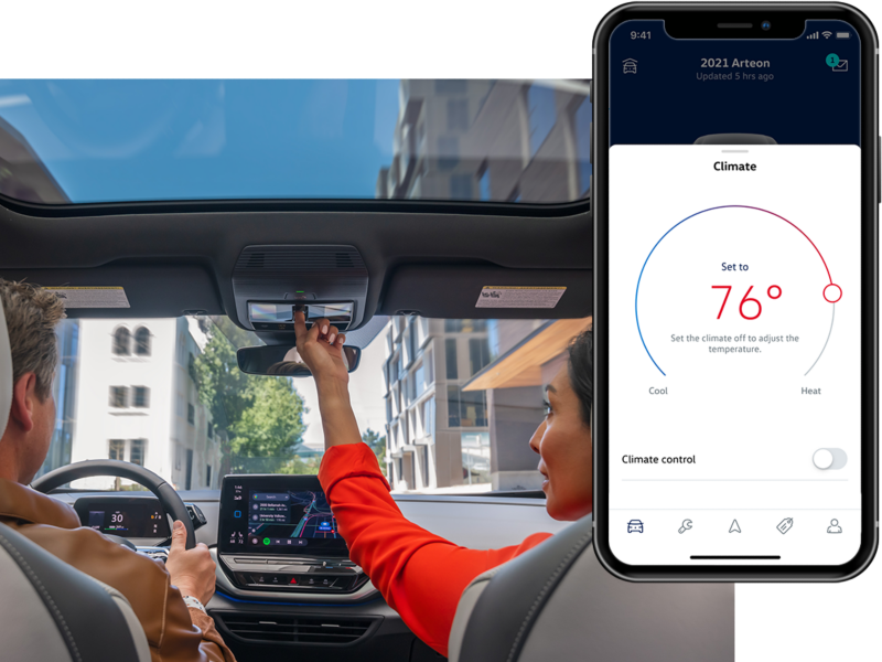 Inside shot of a man and woman in an ID.4. The MyVW app is displayed on a superimposed mobile phone.