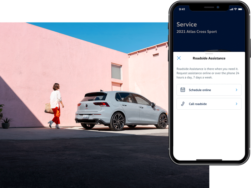 Person walking towards a parked Golf GTI shown in Moonstone Gray. The MyVW app is displayed on a superimposed mobile phone.