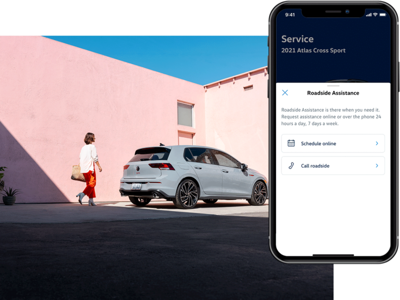 Person walking towards a parked Golf GTI shown in Moonstone Gray. The MyVW app is displayed on a superimposed mobile phone.
