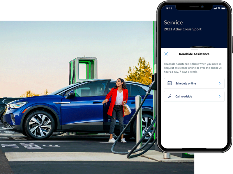 Street level shot of a man and woman meeting next to a parked ID.4 in Dusk Blue Metallic. The MyVW app is displayed on a superimposed mobile phone.