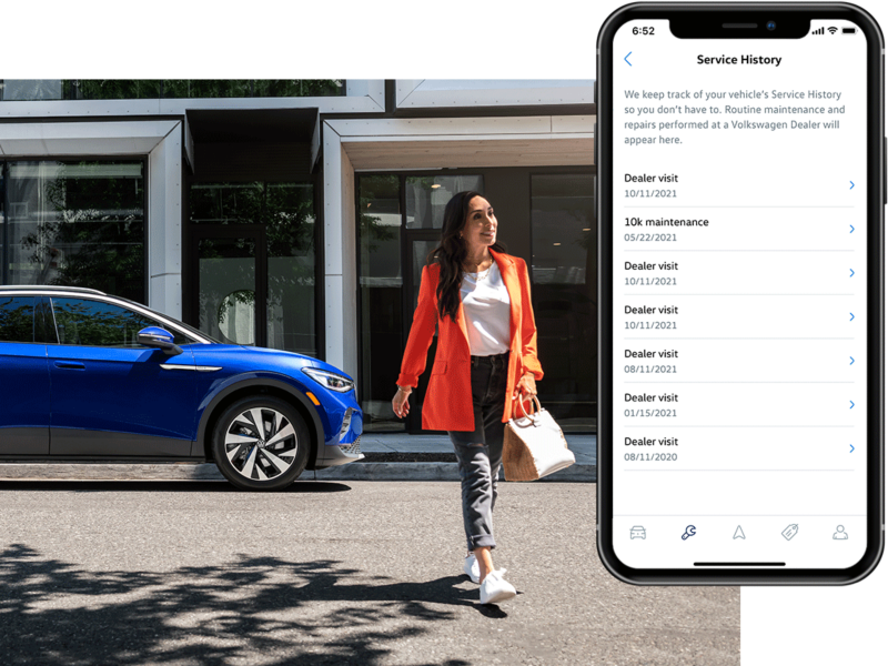 Street level shot of a woman walking away from a parked ID.4 in Dusk Blue Metallic. The MyVW app is displayed on a superimposed mobile phone.