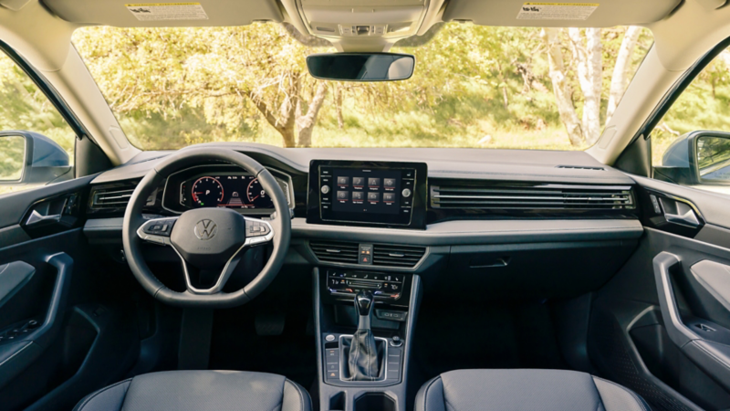 Jetta interior dash highlighting the available leather-wrapped, heated multi-function steering wheel and touchscreen display.