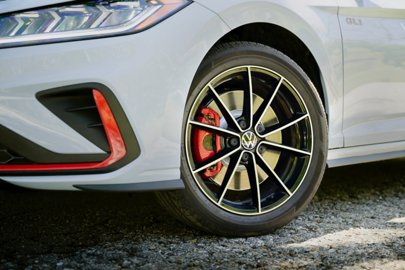 Close up shot showing the front wheel of a Jetta GLI highlighting the red brake caliper. 