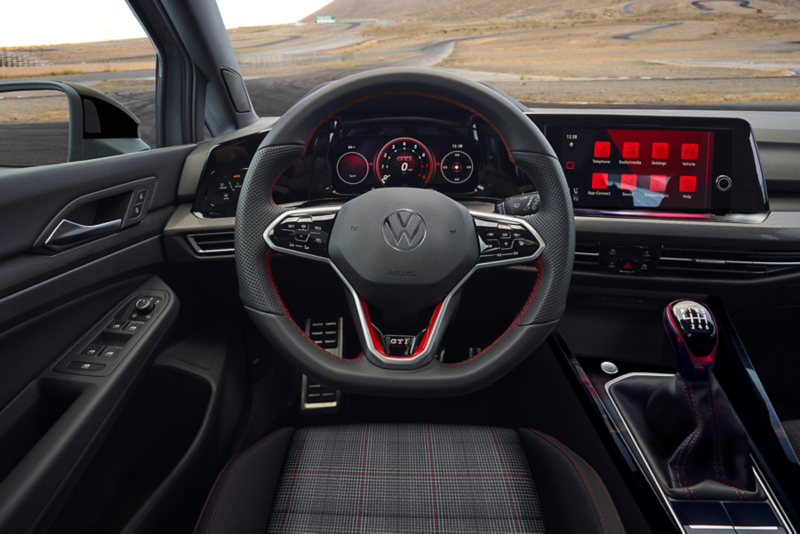 View of driver side interior, leather steering wheel, and digital cockpit.